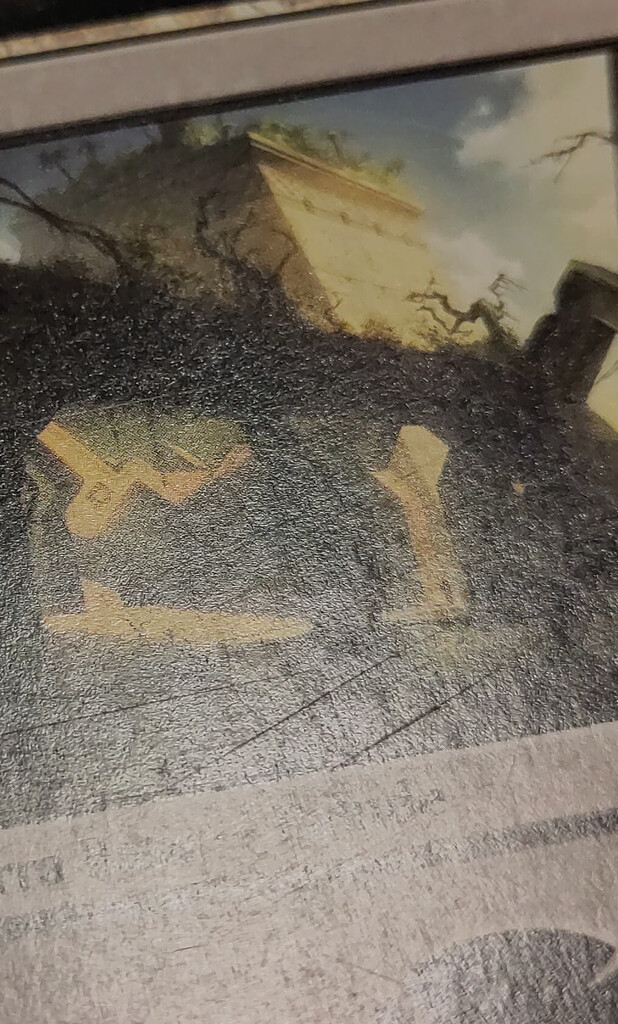 Thin scratches on a card front.