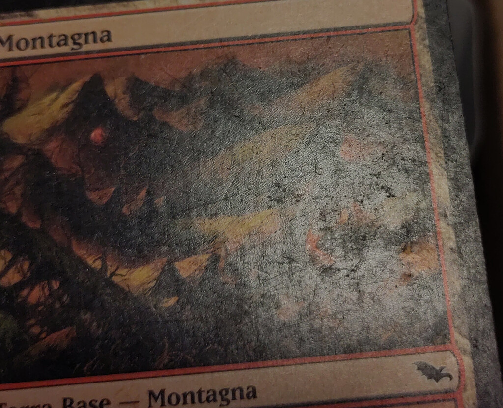 Heavy surface damage on a card surface.